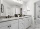 Bathroom with double vanity, black hardware, framed mirror, and white cabinets offering plenty of storage at 353 Belmont Stakes Ln, Wendell, NC 27591