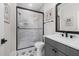 Modern bathroom with tiled shower, black hardware, stylish vanity, and decorative floor tiles at 353 Belmont Stakes Ln, Wendell, NC 27591