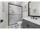 Modern bathroom with tiled shower, black hardware, stylish vanity, and decorative floor tiles at 353 Belmont Stakes Ln, Wendell, NC 27591