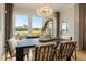 Bright dining room with a large window overlooking the backyard and a modern chandelier at 353 Belmont Stakes Ln, Wendell, NC 27591