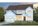 Charming two-story home featuring a two-car garage and a beautifully landscaped front yard at 353 Belmont Stakes Ln, Wendell, NC 27591