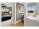 Hallway view leading into the Primary bedroom featuring stylish artwork and wood flooring at 353 Belmont Stakes Ln, Wendell, NC 27591