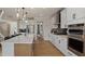 Modern kitchen with a large island, stainless steel appliances, and sleek white cabinetry at 353 Belmont Stakes Ln, Wendell, NC 27591