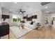 Bright living room featuring contemporary decor, stylish lighting, and a cozy white sofa at 353 Belmont Stakes Ln, Wendell, NC 27591