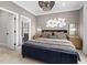 Comfortable bedroom featuring stylish bed, modern lighting, and ensuite bathroom at 353 Belmont Stakes Ln, Wendell, NC 27591
