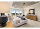 Bright main bedroom with large windows, a tray ceiling, and modern decor at 353 Belmont Stakes Ln, Wendell, NC 27591