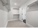 Spacious walk-in closet with carpet and multiple shelving units for ample storage at 353 Belmont Stakes Ln, Wendell, NC 27591
