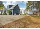 Home's backyard offers a shed, concrete patio, mature trees, and a green lawn at 3746 Guess Rd, Durham, NC 27705
