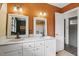 Bathroom featuring double sinks with white countertops and rustic lighting fixtures at 3746 Guess Rd, Durham, NC 27705