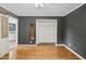 Well-lit bedroom showcases hardwood floors, a sliding closet door, and neutral wall colors at 3746 Guess Rd, Durham, NC 27705