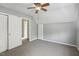 Bedroom with neutral paint, carpet, ceiling fan, and convenient closet space at 3746 Guess Rd, Durham, NC 27705