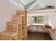 Unique bedroom features lofted bed area with built-in desk, shelves, and natural light from large window at 3746 Guess Rd, Durham, NC 27705