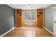 Bright bedroom boasts hardwood floors, built-in shelving, and a large window for natural light at 3746 Guess Rd, Durham, NC 27705