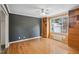 Spacious bedroom featuring hardwood floors, a ceiling fan, and built-in storage solutions at 3746 Guess Rd, Durham, NC 27705