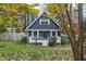 Charming blue two-story home with a cozy front porch and a well-manicured, inviting lawn at 3746 Guess Rd, Durham, NC 27705