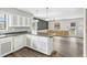 Open kitchen featuring a breakfast bar, white cabinetry, and seamless transition to the dining area at 3746 Guess Rd, Durham, NC 27705