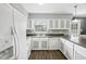 Functional kitchen with white cabinets and appliances, offering ample counter space and storage at 3746 Guess Rd, Durham, NC 27705