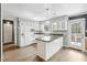 Well-lit kitchen with white appliances, island, and access to outdoor space, perfect for cooking and entertaining at 3746 Guess Rd, Durham, NC 27705