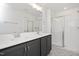 Modern bathroom featuring a double vanity, large mirror, and a glass-enclosed tiled shower at 3933 Willow Gate Way, Knightdale, NC 27604