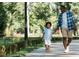 Father and son enjoying a walk on the sidewalk in a natural setting at 3933 Willow Gate Way, Knightdale, NC 27604