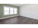 Bright living room features wood floors and expansive windows offering natural light at 3933 Willow Gate Way, Knightdale, NC 27604