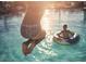 jumps into the sparkling pool, enjoying summer fun in the sun at 3933 Willow Gate Way, Knightdale, NC 27604