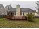 Rear exterior view of home with a wooden deck overlooking a grassy yard at 4212 Birmingham Way, Raleigh, NC 27604