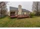 Exterior rear view of home with a deck and a spacious, grassy backyard at 4212 Birmingham Way, Raleigh, NC 27604