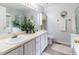 Bright bathroom offers a double vanity, a large mirror, and a walk-in shower at 4212 Birmingham Way, Raleigh, NC 27604