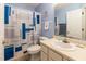 Blue bathroom features a single vanity, and a shower with a patterned curtain at 4212 Birmingham Way, Raleigh, NC 27604