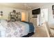 Cozy bedroom features a ceiling fan, TV, white dresser, and a bookcase at 4212 Birmingham Way, Raleigh, NC 27604