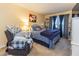 Comfortable bedroom features blue patterned bedding, an armchair, and a bookshelf at 4212 Birmingham Way, Raleigh, NC 27604