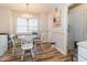 Cozy dining area with a chandelier, hardwood floors, and seating for four at 4212 Birmingham Way, Raleigh, NC 27604