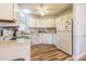 Efficient kitchen featuring white cabinets, updated appliances, and new hardwood flooring at 4212 Birmingham Way, Raleigh, NC 27604