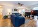 Bright living room featuring a cozy fireplace, hardwood floors, and comfortable seating arrangement at 4212 Birmingham Way, Raleigh, NC 27604