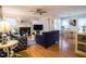 Bright living room featuring a cozy fireplace, hardwood floors, and comfortable seating arrangement at 4212 Birmingham Way, Raleigh, NC 27604