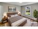 This bedroom has a large window, stylish decor and wood laminate flooring at 4804 Red Coat Ct, Raleigh, NC 27616