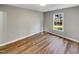 This bedroom has a window and wood laminate flooring at 4804 Red Coat Ct, Raleigh, NC 27616