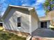 Exterior angle of the home showing the siding, windows, patio, and brick foundation at 4804 Red Coat Ct, Raleigh, NC 27616