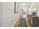Hallway featuring wood floors, decorative trim, and stylish decor at 4879 Pioneer Dr, Sanford, NC 27330