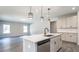 Modern kitchen featuring stainless steel appliances, gray cabinets, and a spacious island at 4879 Pioneer Dr, Sanford, NC 27330