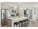 Bright kitchen with white countertops, gray cabinets, stainless appliances, and four bar stools at 4879 Pioneer Dr, Sanford, NC 27330