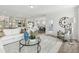 Bright and airy living room featuring hardwood floors, neutral decor, and an open floor plan at 4879 Pioneer Dr, Sanford, NC 27330