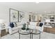 Open living area featuring dual sofas, hardwood floors, and open access to the modern kitchen at 4879 Pioneer Dr, Sanford, NC 27330