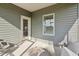 Outdoor patio area with seating, view of a yard and fields through the door and window at 4879 Pioneer Dr, Sanford, NC 27330