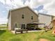 A home's backyard features an outdoor kitchen and lounge area for entertaining at 516 Spaulding St, Burlington, NC 27215