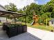 This backyard includes a covered patio seating area with backyard playset at 516 Spaulding St, Burlington, NC 27215