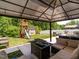 View of the backyard featuring a playground, outdoor kitchen, patio, and gazebo at 516 Spaulding St, Burlington, NC 27215