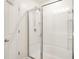Bathroom featuring white shower with glass doors, white door and chrome hardware at 516 Spaulding St, Burlington, NC 27215