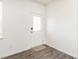 Bright entryway featuring a white door with decorative glass and durable laminate flooring at 516 Spaulding St, Burlington, NC 27215